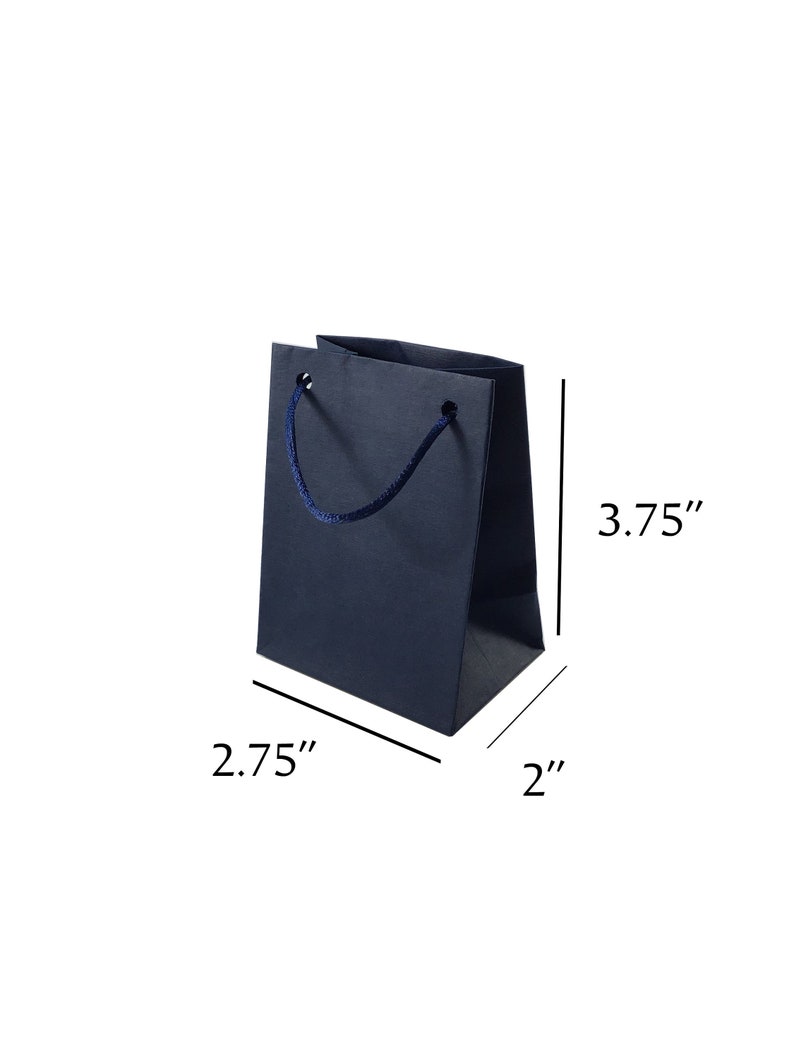 May include: A small, dark blue gift bag with a navy blue rope handle. The bag measures 3.75 inches tall, 2.75 inches wide, and 2 inches deep.