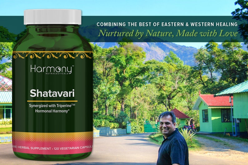 May include: A green bottle of Shatavari herbal supplement with the words "Harmony Nutraceuticals" and "Synergized with Triperine&trade; Hormonal Harmony&trade;" on the label. The bottle is sitting on a table in front of a green landscape with houses in the background.