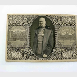Op de afbeelding: Antieke zwart-wit bankbiljet met een portret van een man in een formele jas en medailles. De bankbiljet heeft sierlijke randen met architecturale illustraties en de data 1848 en 1908. Tekst is onderaan gedrukt.