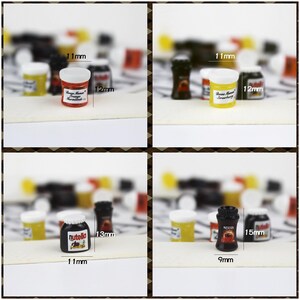 May include: Four miniature glass jars with labels and white lids. The jars are filled with different colored liquids. The jars are 1.1 inches tall and 1.3 inches wide. The labels on the jars read "Orange Marmalade", "Strawberry", "Nutella", and "Nescafe".