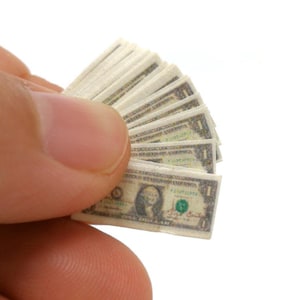 May include: A miniature stack of US dollar bills, fanned out and held in a hand. The bills are printed with the image of George Washington and the denomination "One Dollar".