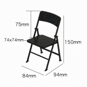 May include: Black folding chair with a 74x74mm seat, 75mm back height, 150mm overall height, 84mm width, and 94mm depth.
