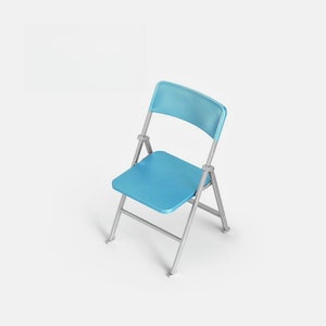 May include: A light blue folding chair with a silver frame. The chair is made of plastic and metal.