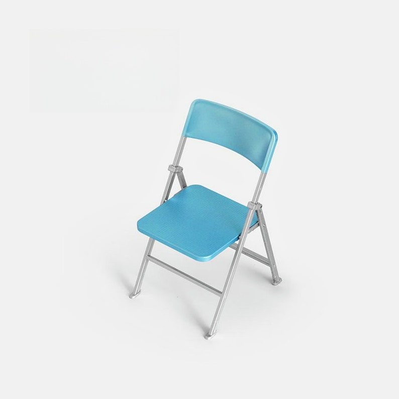 May include: A light blue folding chair with a silver frame. The chair is made of plastic and metal.
