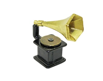 May include: A miniature black and gold gramophone with a decorative horn. The gramophone has a small round turntable and a base with a decorative design.