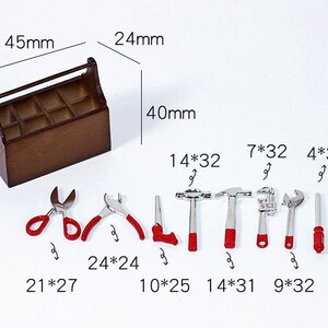 May include: A wooden toolbox with a handle and nine compartments, containing a set of miniature tools with red handles. The tools include a pair of scissors, pliers, a saw, two hammers, a wrench, and a screwdriver. The toolbox measures 4.5 inches by 2.4 inches by 4 inches.