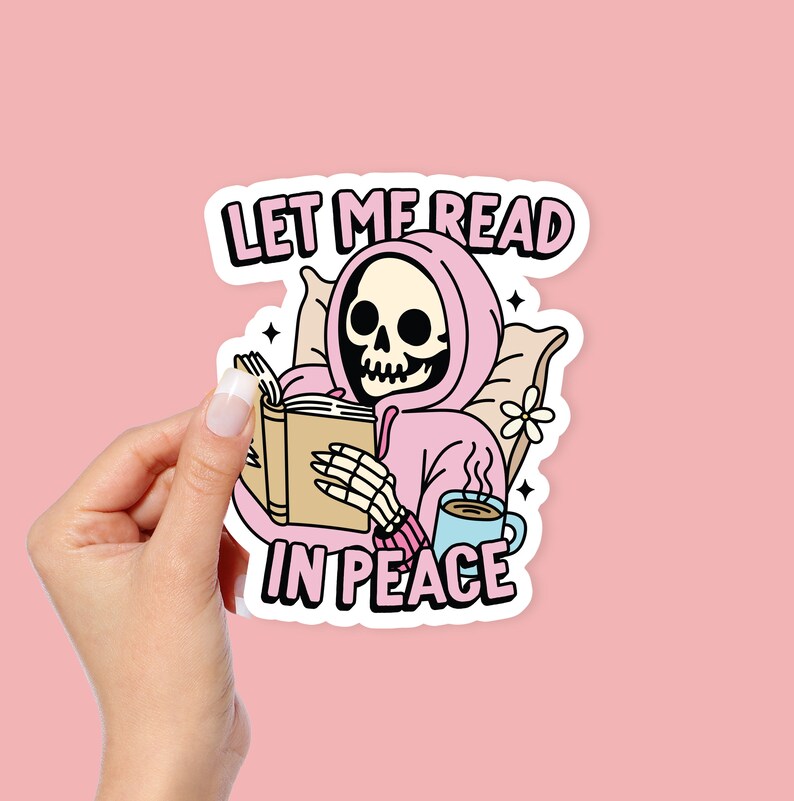 May include: A pink sticker with a skeleton wearing a pink hoodie and reading a book. The text on the sticker says "Let me read in peace".