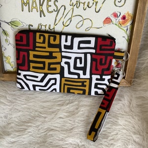 Muñequera negra, dorada y roja, neceser de maquillaje, cartera, neceser
