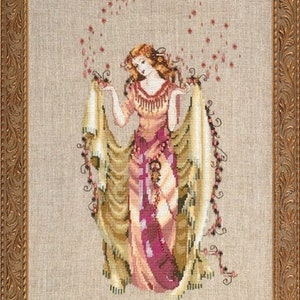 May include: A cross-stitch embroidery of a woman in a flowing gown with a floral pattern. She is surrounded by a swirl of pink flowers. The embroidery is framed in a gold frame.