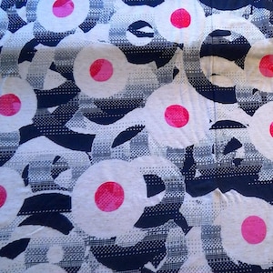 May include: White fabric with a repeating pattern of pink circles on a navy blue background.