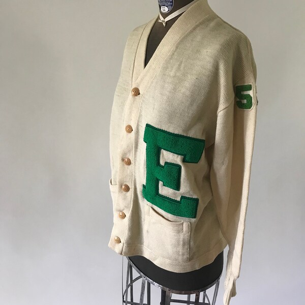 Vintage 1950s tan knit letterman cardigan with green E and the number 53 in green on the left shoulder button front