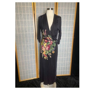 May include: A black maxi dress with a floral print and a wrap style. The dress has a V-neckline and 3/4 sleeves.