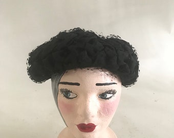 Vintage 1950s black hat with gathered detail and net veil,
