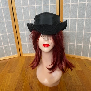 Vintage 1950’s black wool felt hat with ribbon and birdcage veil