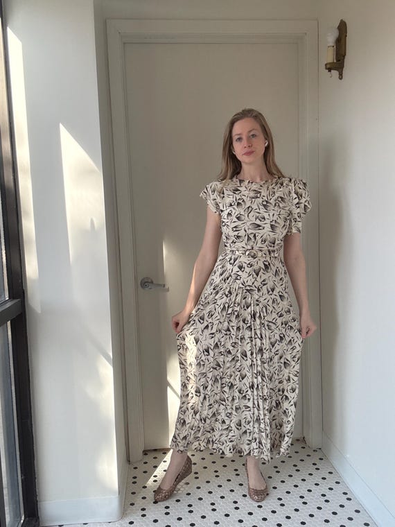 vintage asymmetrical dress Vintage 1940’s black and white tulip print dress with asymmetrical details,  size small