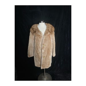 May include: A brown faux fur coat with a large collar and button closure.