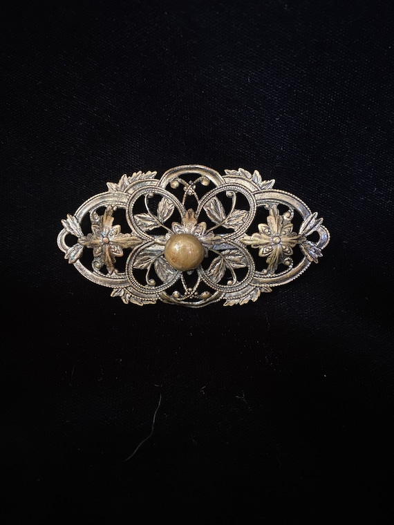 Antique bronze brass colored delicate curly brooch