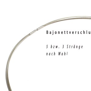 May include: A close-up of a silver-colored necklace with a bayonet clasp. The necklace is composed of multiple strands. Text in the image reads "Bajonettverschluss" and "5 bzw. 3 Str&auml;nge nach Wahl."