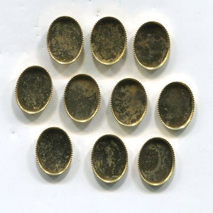 May include: Ten gold-colored oval-shaped metal trays with a decorative edge. The trays are empty and ready to be filled with resin, paint, or other materials.