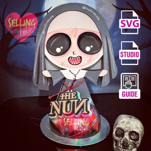 May include: A digital cut file of a cartoon nun with the text "The Nun" and "Selling with Love" on a red heart. The file is available in SVG, Studio, and Guide formats.