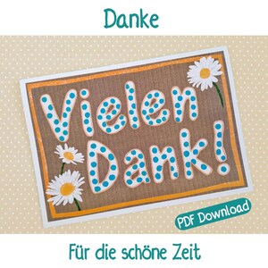 May include: A rectangular card with the words "Vielen Dank!" in large, blue polka-dotted letters. The card has an orange border and is decorated with daisy illustrations. The text "Danke" is at the top, and "Für die schöne Zeit" is at the bottom.