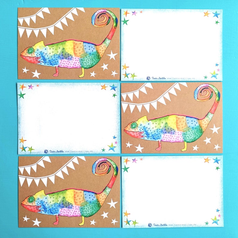 May include: Set of six greeting cards featuring a colorful chameleon illustration. Each card has a brown background with a white banner and star accents. The chameleon is painted in rainbow hues. The cards have a white space for writing.