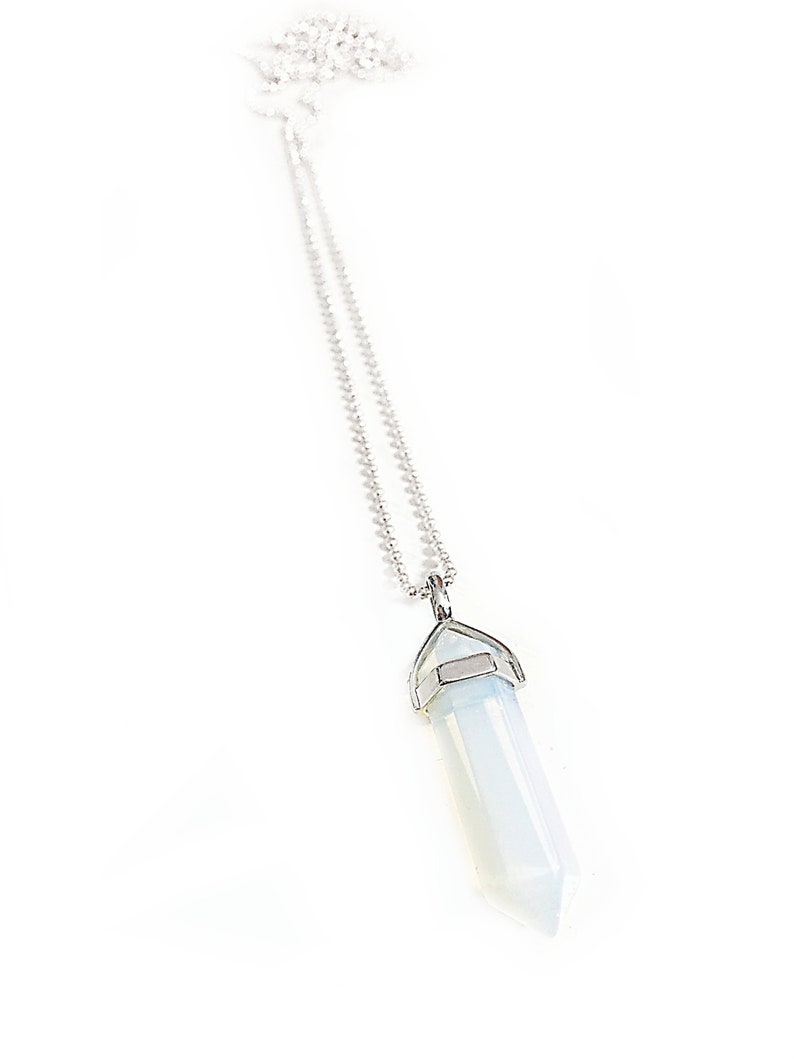 May include: A silver chain necklace with a white opal point pendant.