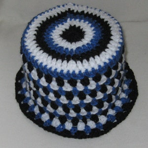May include: A crocheted hat with a black, white, and blue color pattern. The hat has a round crown and a wide brim.