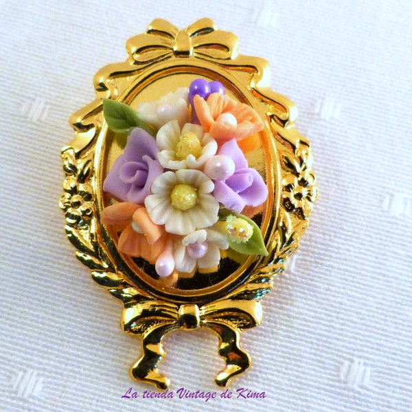 Golden brooch with red flowers