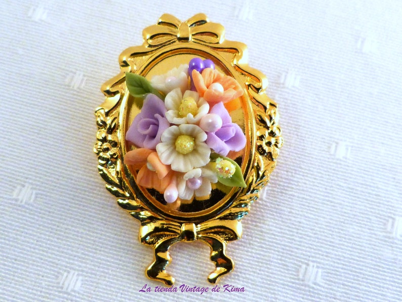 Golden brooch with red flowers image 1