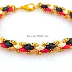 May include: A multi-colored beaded bracelet with gold accents. The bracelet features black, white, pink, and beige beads.