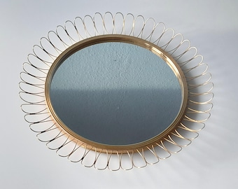 Vintage wall mirror with brass loops