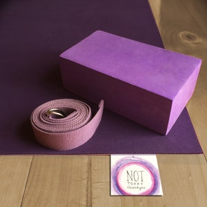 May include: Purple yoga mat with a purple yoga block and a purple yoga strap. A card with the text "NOT TODAY thank you" is on the wooden surface.