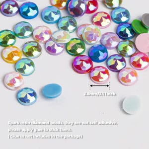 May include: Assortment of iridescent resin diamond beads in various colors, including pink, blue, green, and yellow. The beads are 2.8 mm in diameter and are not self-adhesive.  Spark resin diamond beads, they are not self-adhesive, please apply glue to stick them. (Glue in not includes in the package)