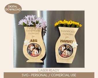 May include: Two wooden vase-shaped photo frames with a picture of two children in each. The frames are decorated with flowers and the text "Handpicked Flowers for" and either "Abu" or "Mommy".