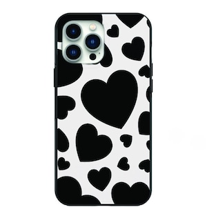 May include: Black and white phone case with a pattern of hearts.