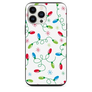 May include: A white iPhone case with a pattern of green, red, and blue Christmas lights and snowflakes.