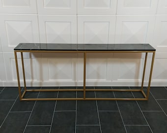 A handcrafted console with a metal base and a marble or quartz conglomerate top. Perfect for the living room, office, hall.