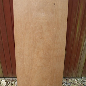 May include: A large, rectangular piece of unfinished wood with rounded edges. The wood is light brown in colour and has a smooth surface.