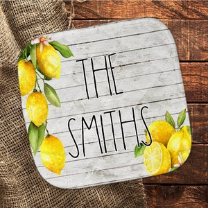 May include: White wooden sign with the text "THE SMITHS" in black lettering. The sign is decorated with a watercolor illustration of lemons and leaves.