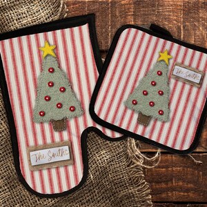 May include: Set of two red and white striped pot holders with a green Christmas tree and the text "The Smiths" on one and "The Smiths" on the other.