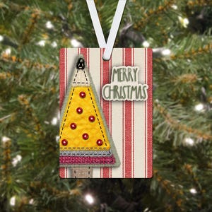 May include: A rectangular Christmas ornament with a yellow tree design, red star accents, and the words "MERRY CHRISTMAS." The ornament has a striped background with a white ribbon for hanging. The tree is outlined in black.