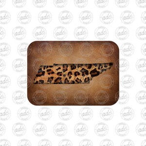 May include: A brown leather background with a cutout of the state of Tennessee. The cutout is filled with a leopard print pattern.