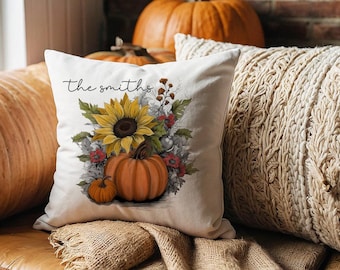 May include: White throw pillow with the text "the smiths" and a floral design featuring sunflowers and pumpkins.