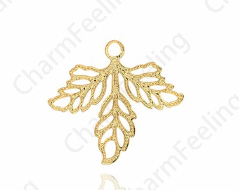 May include: Gold-toned metal leaf charm with a delicate, intricate design. The charm has a loop at the top for attaching to jewelry or other crafts.