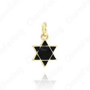 May include: A gold-colored pendant featuring a black Star of David design. The pendant has a small loop at the top for attaching to a chain or bracelet. The star is a six-pointed star with a black enamel center.