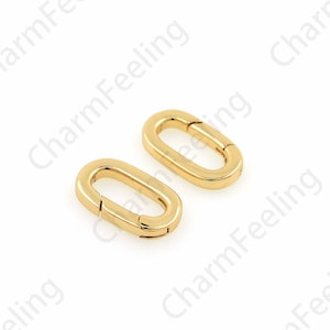 May include: Two gold-toned metal oval-shaped clasps with a spring-loaded closure.
