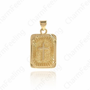 May include: Gold pendant featuring a cross design with a textured surface. The pendant is rectangular in shape and has a shiny finish.