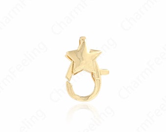 May include: Gold-toned star-shaped charm clasp for jewelry making. The clasp is a small, round loop with a star-shaped closure.