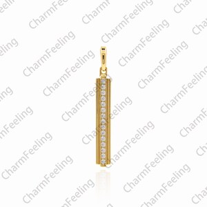 May include: A gold pendant with a vertical bar design. The bar is set with small, clear stones.